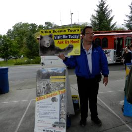 Owner with Sitka Scenic Tours sign