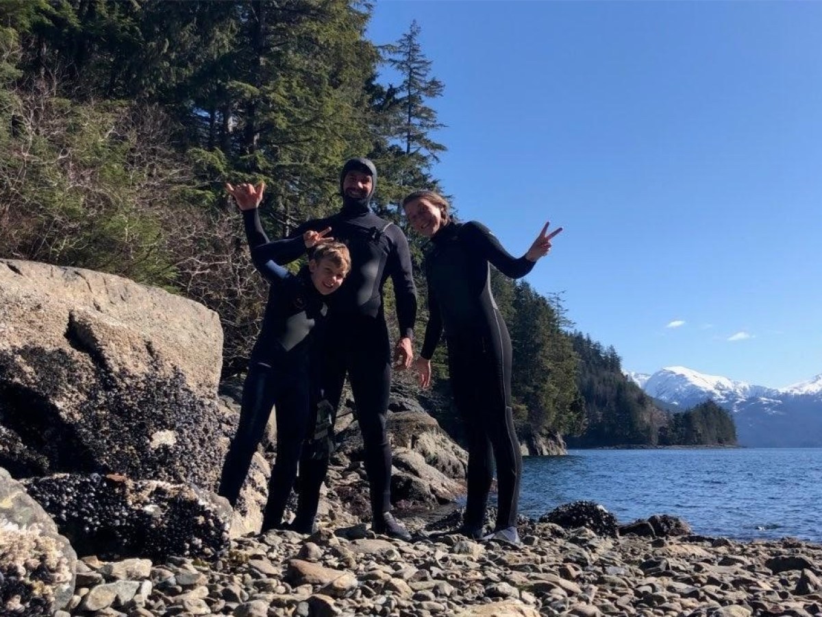 a man standing on a rocky beach
